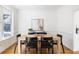 Dining room with a wood table, black chairs, stylish decor, and natural light at 184 Scott St, Daniel Island, SC 29492