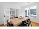 Bright dining room with hardwood floors, modern table and chairs, and a view of the front porch at 184 Scott St, Daniel Island, SC 29492