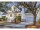 Beautiful white home featuring an attached two-car garage and a charming covered front porch at 184 Scott St, Daniel Island, SC 29492