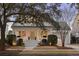 Beautiful home with mature trees, an American flag, and a cozy front porch at 184 Scott St, Daniel Island, SC 29492