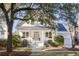 Charming two-story traditional home with white trim, manicured landscaping, and welcoming front porch at 184 Scott St, Daniel Island, SC 29492