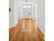 Long hallway featuring hardwood floors and white trim leading to bright living space at 184 Scott St, Daniel Island, SC 29492