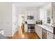 Modern kitchen features stainless steel appliances, white cabinetry, and hardwood floors at 184 Scott St, Daniel Island, SC 29492