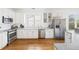 Well-lit kitchen with stainless steel appliances, white cabinetry, and hardwood floors at 184 Scott St, Daniel Island, SC 29492