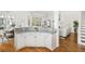 Bright kitchen featuring white cabinetry, granite countertops, hardwood floors and stainless steel appliances at 184 Scott St, Daniel Island, SC 29492