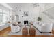 Bright living room with vaulted ceilings, white walls, fireplace, and neutral decor at 184 Scott St, Daniel Island, SC 29492
