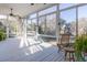 Comfortable screened-in porch with wood flooring, a ceiling fan, and views of the surrounding landscape at 184 Scott St, Daniel Island, SC 29492