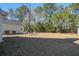 The grassy backyard has lawn chairs, and a detached garage with yard access at 1945 Hubbell Dr, Mount Pleasant, SC 29466