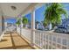 Relaxing covered balcony with white railing offering neighborhood views and hanging plants at 1945 Hubbell Dr, Mount Pleasant, SC 29466