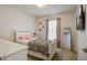 Charming bedroom with neutral walls, featuring a single bed with a floral patterned coverlet and TV at 1945 Hubbell Dr, Mount Pleasant, SC 29466