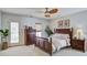 Bright bedroom features a ceiling fan, neutral walls, a door to the outside, and elegant, dark wood furniture at 1945 Hubbell Dr, Mount Pleasant, SC 29466