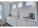 Bright breakfast bar area with white cabinets, granite countertops, and shiplap walls at 1945 Hubbell Dr, Mount Pleasant, SC 29466