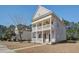 Charming two-story home with a double porch, white columns, and manicured landscaping at 1945 Hubbell Dr, Mount Pleasant, SC 29466