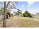 Expansive backyard featuring mature trees, a red shed, a partially-fenced perimeter, and plenty of space at 2005 Nitsa St, Johns Island, SC 29455