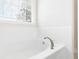 Bright bathtub area with tiled walls and window with blinds at 2005 Nitsa St, Johns Island, SC 29455