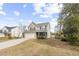 Charming two-story home with vinyl siding, a two-car garage, and a well-manicured lawn at 2005 Nitsa St, Johns Island, SC 29455
