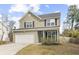 Charming two-story home with a well-manicured lawn, attached garage, and welcoming front porch at 2005 Nitsa St, Johns Island, SC 29455