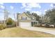 Two-story home with a two-car garage, dark shutters and a well-manicured front lawn at 2005 Nitsa St, Johns Island, SC 29455