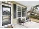 Inviting front porch with seating area, creating a cozy and welcoming entrance to the home at 2005 Nitsa St, Johns Island, SC 29455