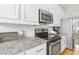 Close up of kitchen featuring stainless steel appliances, granite countertops, and tile backsplash at 2005 Nitsa St, Johns Island, SC 29455