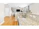 Modern kitchen with stainless steel sink, granite countertops, and hardwood floors at 2005 Nitsa St, Johns Island, SC 29455