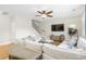 Open concept living room with ceiling fan, hardwood floors, and staircase at 2005 Nitsa St, Johns Island, SC 29455