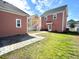Landscaped backyard featuring a stone paver pathway and well-manicured lawn at 2014 Codorus Ln, Hanahan, SC 29410