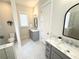 Elegant bathroom featuring dual sinks, marble countertops, and a glass shower enclosure at 2014 Codorus Ln, Hanahan, SC 29410