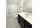 Bright bathroom featuring a tub-shower combo, vanity with sink and dark wood cabinets at 2014 Codorus Ln, Hanahan, SC 29410