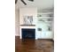 Detailed view of a modern fireplace with mantel, decorative shelving, and shiplap accent wall at 2014 Codorus Ln, Hanahan, SC 29410