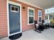 Inviting front porch featuring rocking chairs, a stylish door, and attractive, neutral exterior at 2014 Codorus Ln, Hanahan, SC 29410