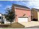 Detached garage with basketball hoop, paved driveway and tree in yard at 2014 Codorus Ln, Hanahan, SC 29410