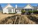 The backyard with a well maintained lawn and view of the house, including the screened-in porch at 2080 Bancroft Ln, Mount Pleasant, SC 29466
