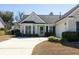Charming home featuring a two-car garage, well-manicured bushes, and a concrete driveway at 2080 Bancroft Ln, Mount Pleasant, SC 29466