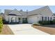 Charming home featuring a two-car garage, well-manicured bushes, and a concrete driveway at 2080 Bancroft Ln, Mount Pleasant, SC 29466