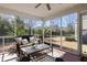 Relaxing screened porch with comfortable furniture and views of the backyard at 2080 Bancroft Ln, Mount Pleasant, SC 29466
