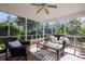 Inviting sunroom featuring wicker furniture, ceiling fan, and views of the lush backyard at 2080 Bancroft Ln, Mount Pleasant, SC 29466