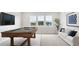 Game room with pool table, sofa, wall mounted TV, and large windows with scenic views at 231 Denham St, Summerville, SC 29486