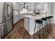 Bright kitchen with a large island, stainless steel appliances, quartz countertops, and dark hardwood floors at 234 Evergreen Ave, Summerville, SC 29485