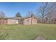 A grassy backyard featuring the back of a brick home at 2529 Otranto Rd, North Charleston, SC 29406