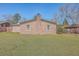 Spacious backyard with a brick home featuring a chimney at 2529 Otranto Rd, North Charleston, SC 29406