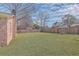 Spacious backyard with a wooden fence and brick home at 2529 Otranto Rd, North Charleston, SC 29406