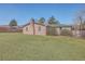 Wide view of a backyard, showing the lawn, fence and the back of a brick home at 2529 Otranto Rd, North Charleston, SC 29406
