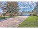 Charming brick home features an attached garage, a spacious driveway, and a well-maintained front lawn at 2529 Otranto Rd, North Charleston, SC 29406