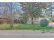 Inviting brick home with lush front lawn and mature trees, offering a serene and welcoming curb appeal at 2529 Otranto Rd, North Charleston, SC 29406