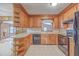 Bright kitchen featuring wood cabinets, tiled backsplash, and modern appliances at 2529 Otranto Rd, North Charleston, SC 29406