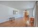 Spacious living room with gleaming hardwood floors, a large window, and an open layout leading to the dining area at 2529 Otranto Rd, North Charleston, SC 29406