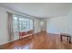 Sunlit living room featuring gleaming hardwood floors, a large window, and an open layout at 2529 Otranto Rd, North Charleston, SC 29406