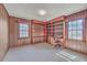 Office with wood paneling, built-in bookshelves, and carpet at 2529 Otranto Rd, North Charleston, SC 29406