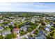 Scenic aerial view showcases a neighborhood nestled around a pond, surrounded by mature trees and landscaping at 2664 Magnolia Woods Dr, Mount Pleasant, SC 29464